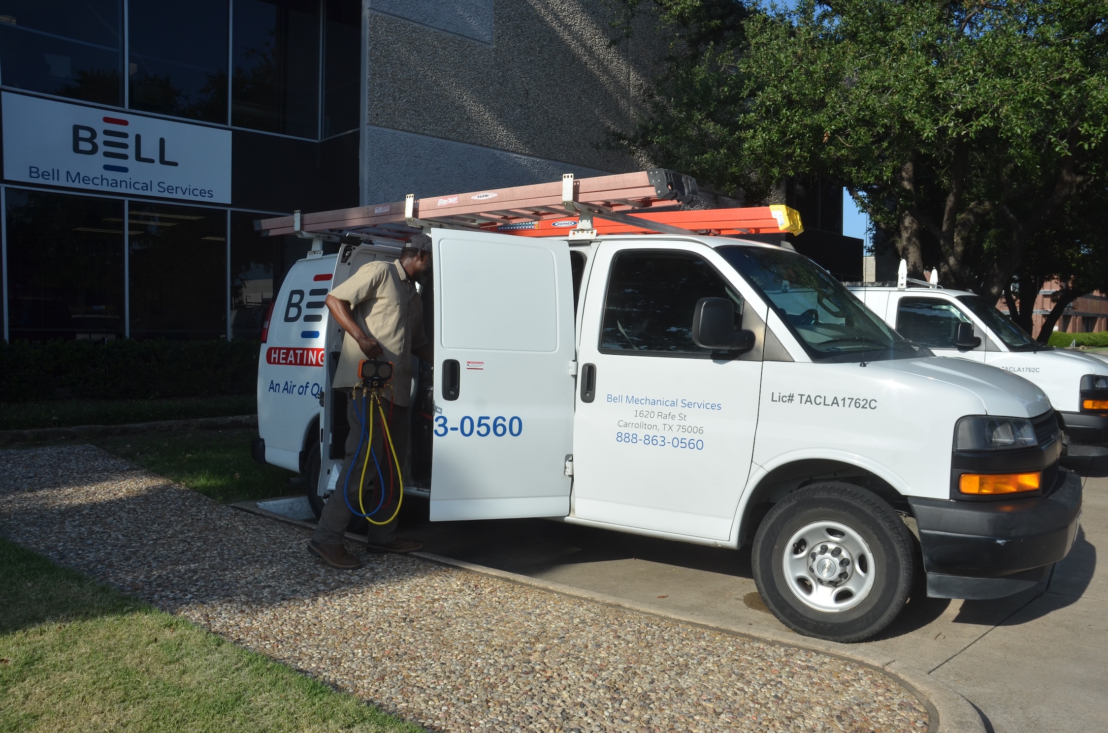 Bell Mechanical service vans parked outside the company facility