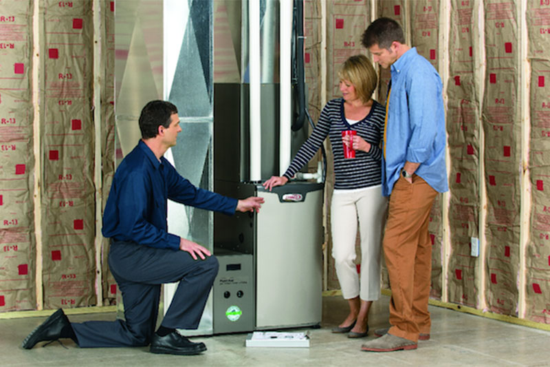 Bell Mechanical technician installing an energy-efficient furnace