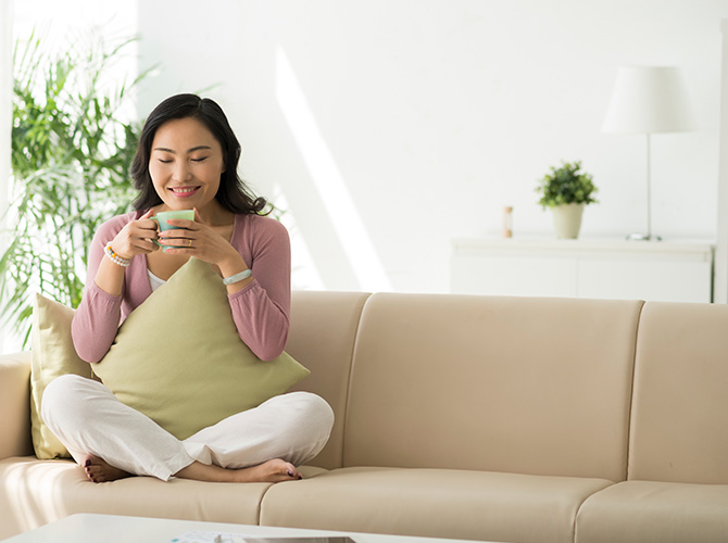 Woman relaxing in a warm, comfortable home