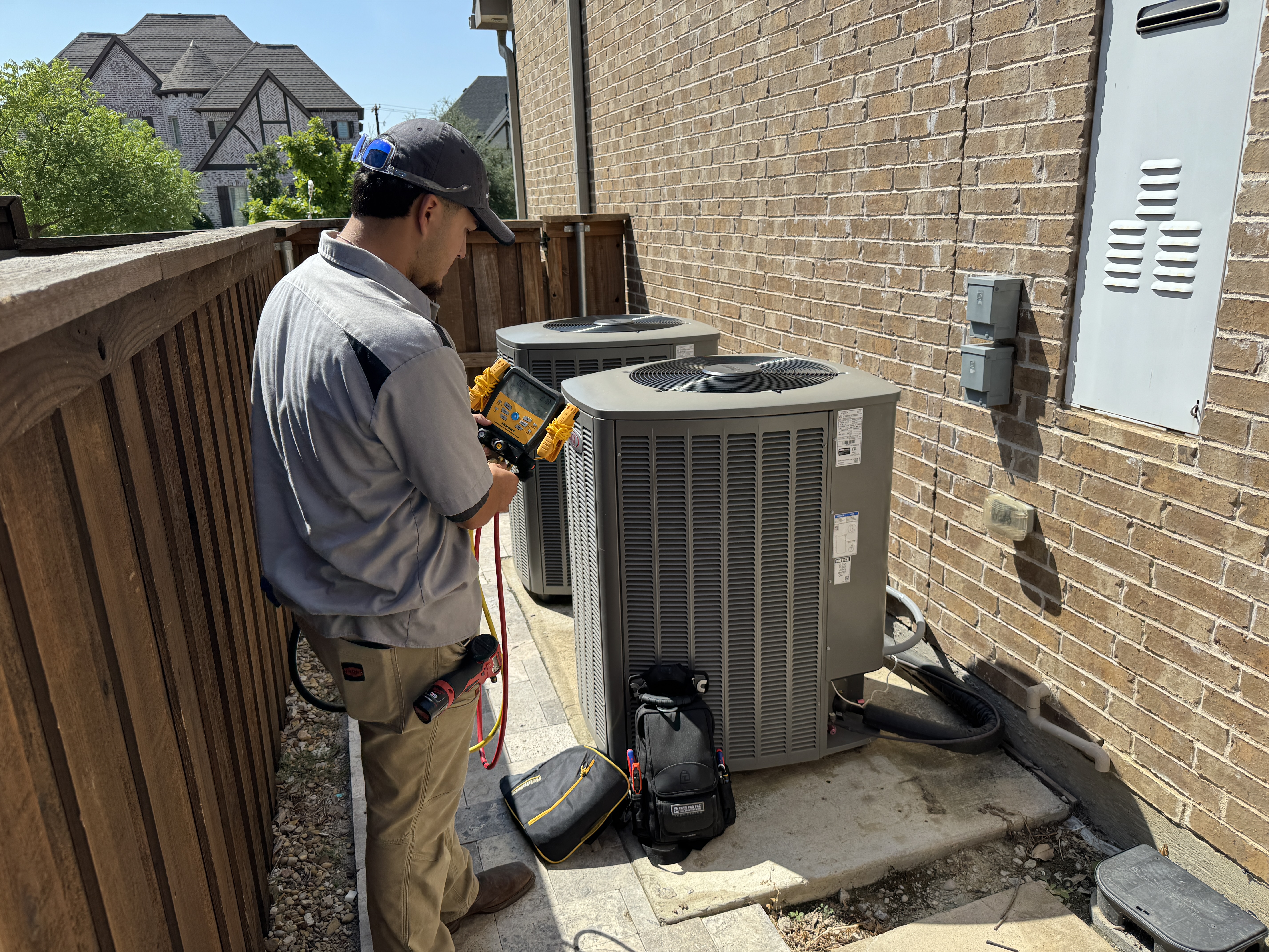 A Bell Mechanical technician greets a homeowner at the door for a scheduled tune-up